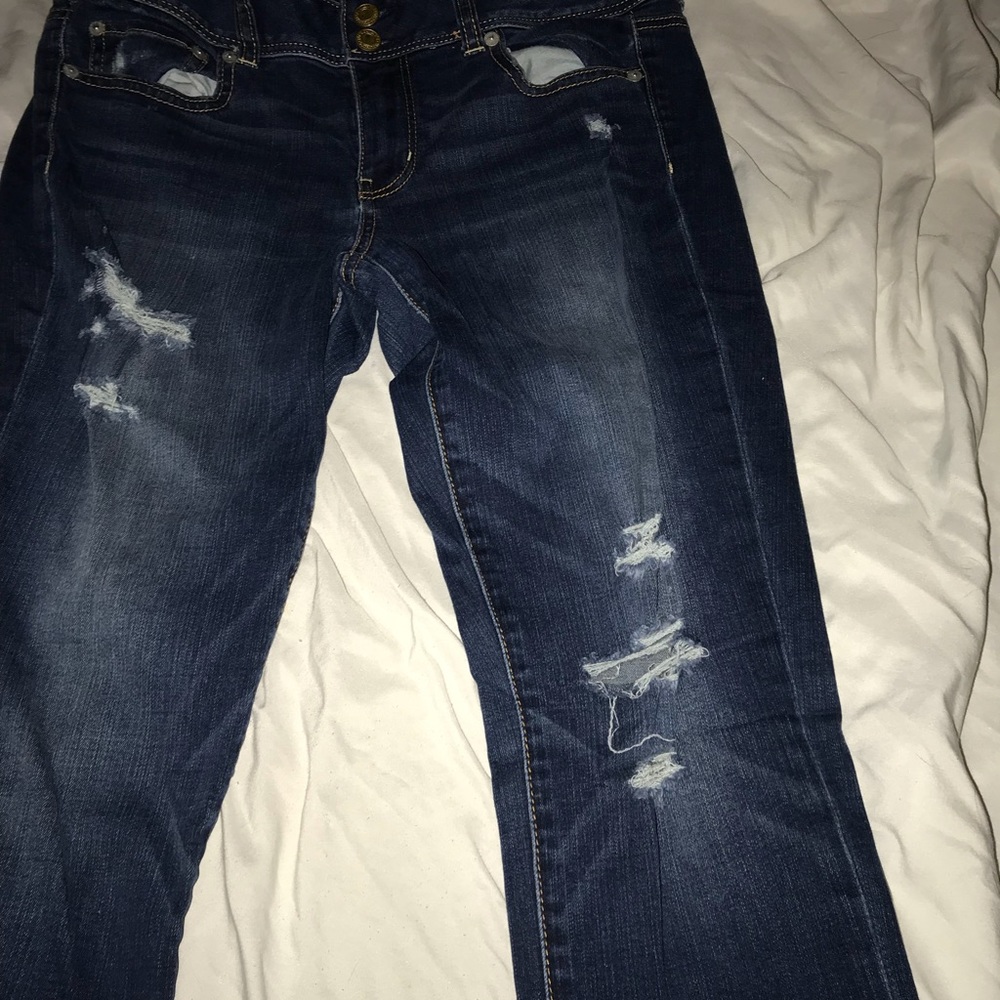 Dark blue skinny jeans with rips on bottom legs